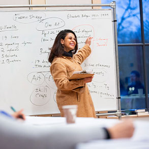Photo of a teacher giving a lecture to a class of students. Read about Gifts of Cash, Checks, and Credit Cards 
