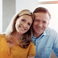 Couple smiling and looking at camera